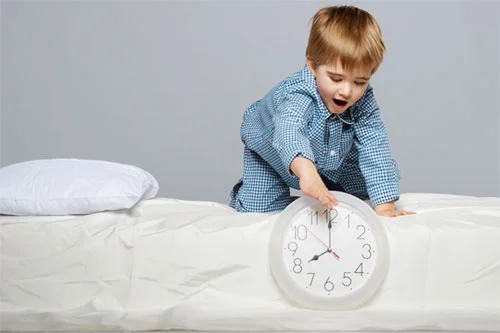 Child winding back clock